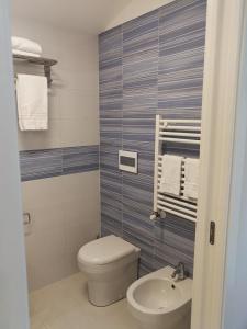 a bathroom with a toilet and a sink at La Finestra sul Mare in Letojanni