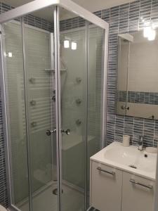 a bathroom with a shower and a sink at La Finestra sul Mare in Letojanni