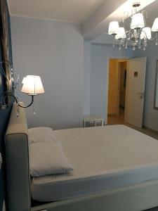 a large bed in a room with a lamp at La Finestra sul Mare in Letojanni