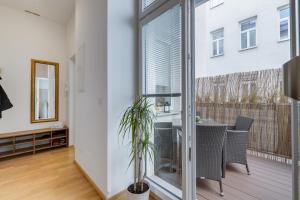 a living room with a window and a table with a plant at Modern Vienna in Vienna