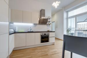 a kitchen with white cabinets and a counter top at Modern Vienna in Vienna