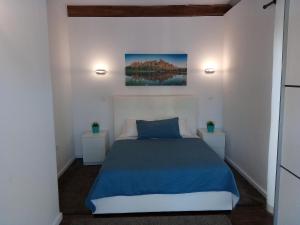 a bedroom with a blue bed and two night stands at Country House Casa dos Chaves in Vila do Conde
