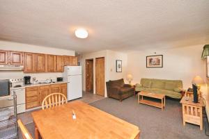 a kitchen and a living room with a table at River View Resort in Bethel
