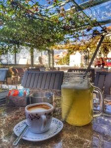 a cup of coffee and a drink on a table at Apartmani Armonia in Perast