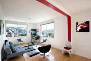 a living room with a couch and a table at The Best View 120M2 Panoramic View Private Garage in Étretat