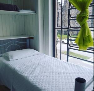 a bedroom with a white bed and a window at Casa de Pedra Mineira in Canela +19 photos