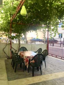a table and chairs sitting under a pergola at DK Apartmani in Dobra Voda
