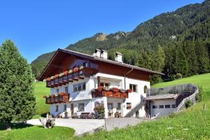 een gebouw met bloembakken aan de zijkant bij Haus Pötzes in Castelrotto