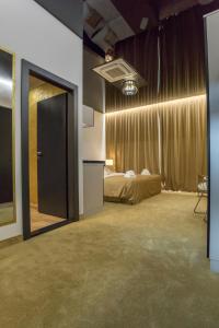 a room with a bed and a door to a bedroom at Apart Hotel GOLDEN apartments in Košice