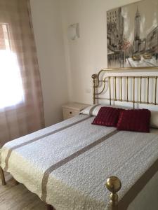 a bedroom with a bed with red pillows on it at Nuovo Appartamento In Centro in Pula