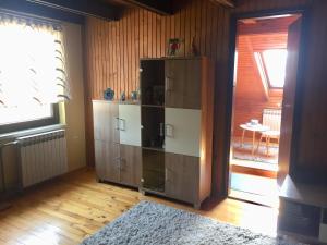 a large wooden cabinet in a room with a window at Villa Irena in Visoko