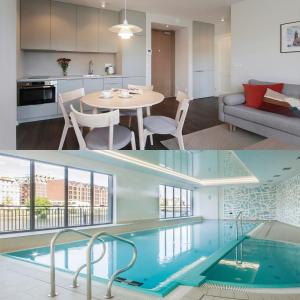 a kitchen and a living room with a swimming pool at EGH Waterlane Island Apartment in Gdańsk