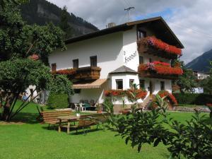 a building with a table and benches in front of it at sHoamatl in Pfunds
