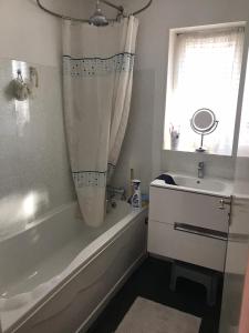 a bathroom with a bath tub and a sink at Double J8 m27 in Southampton