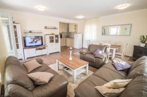a living room with two couches and a table at Queen Teuta - Sea View - Private Parking & Garden - BBQ Grill in Risan