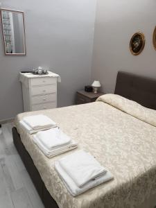 a bedroom with a bed with towels on it at Matteotti Apartment in Rapallo