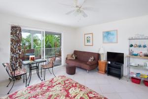 a living room with a bed and a couch and a table at Bears' Place Guest House in Kailua-Kona