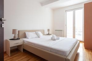מיטה או מיטות בחדר ב-Urban Serviced Apartments