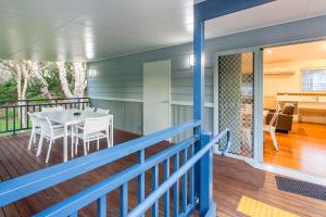 a porch with a table and chairs on a deck at BIG4 Sawtell Beach Holiday Park in Sawtell