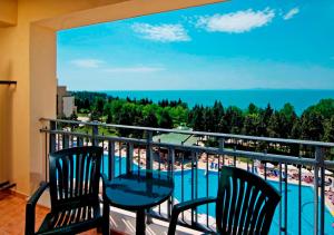 a balcony with two chairs and a view of the beach at SOL by Meliá Nessebar Palace All Inclusive in Nesebar