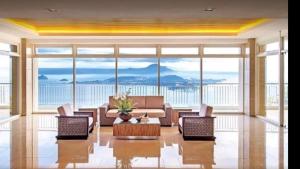 a living room with a couch and chairs and a table at Wind Residences cool breeze & amazing tagaytay view in Tagaytay