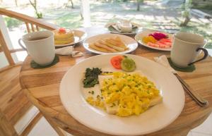 a wooden table with plates of food on it at Parthi Puri Ubud in Ubud