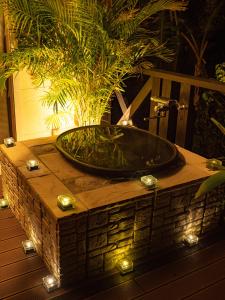 a bath tub sitting on top of a table with lights at Yakushima Cottage Morino Fairy in Yakushima