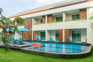 a villa with a swimming pool in front of a building at Anja Jimbaran in Jimbaran