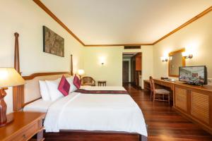 a hotel room with a bed and a desk at Khaolak Bayfront Resort in Khao Lak