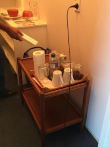 a table with toilet paper and cups on it at A Cozy Room with It's Own Privacy in Upper Hutt