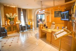 a salon with a cash register and flowers in a room at Best Western Beauséjour in Lourdes