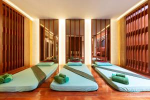 two beds in a room with large windows at Khaolak Bayfront Resort in Khao Lak