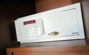 a microwave oven sitting on top of a wooden cabinet at D Apartment in Pattaya