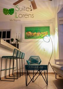 a room with two chairs and a table and a lamp at Suites Lorens in Isla Mujeres