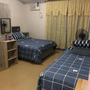 Ένα ή περισσότερα κρεβάτια σε δωμάτιο στο Cubao ManhattanHeights Unit 7EF Tower B, 1BR