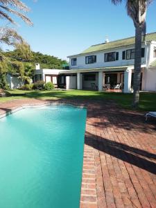 a house with a swimming pool in front of it at Point Lodge Knysna in Knysna