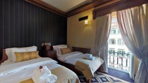 Voodi või voodid majutusasutuse Historic Boutique Hotel Cattaro toas