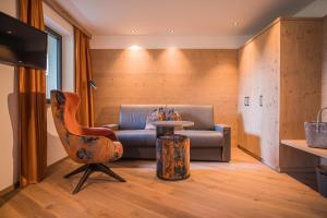 a living room with a couch and a table at Panorama Hotel Himmelreich in Castelbello-ciardes