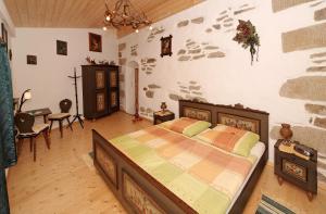 a bedroom with a large bed in a room at Ferienhaus Rachelblick in Kirchberg