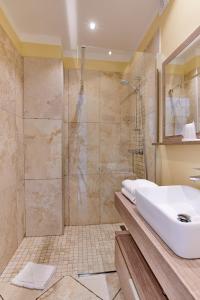 y baño con lavabo y ducha. en Hôtel restaurant le Ressac, en Campomoro