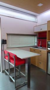a kitchen with a table and chairs in it at Room Motels Gympie in Gympie
