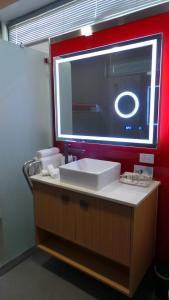 a bathroom with a sink and a mirror at Room Motels Gympie in Gympie