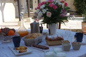 a table with a bunch of food and flowers at LA MAISON DE ROSE in Limeray