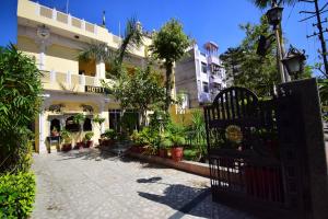 a gate in front of a building with plants at Bani Park Hotel in Jaipur