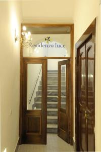 a entrance to a building with a reflection of a staircase at Residenza Luce in Amalfi