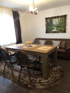 a dining room table with chairs and a couch at Casa Maria in Bran