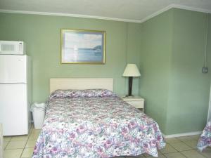 En eller flere senger på et rom på Bayfront Cottages