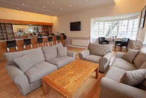 a living room with couches and a coffee table at The Management Centre in Bangor