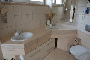 a bathroom with two sinks and a toilet at Ubytování Pod Cimburkem in Městečko Trnávka