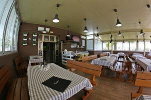 a restaurant with tables and chairs in a room at Room and Apartment Doris in Umag